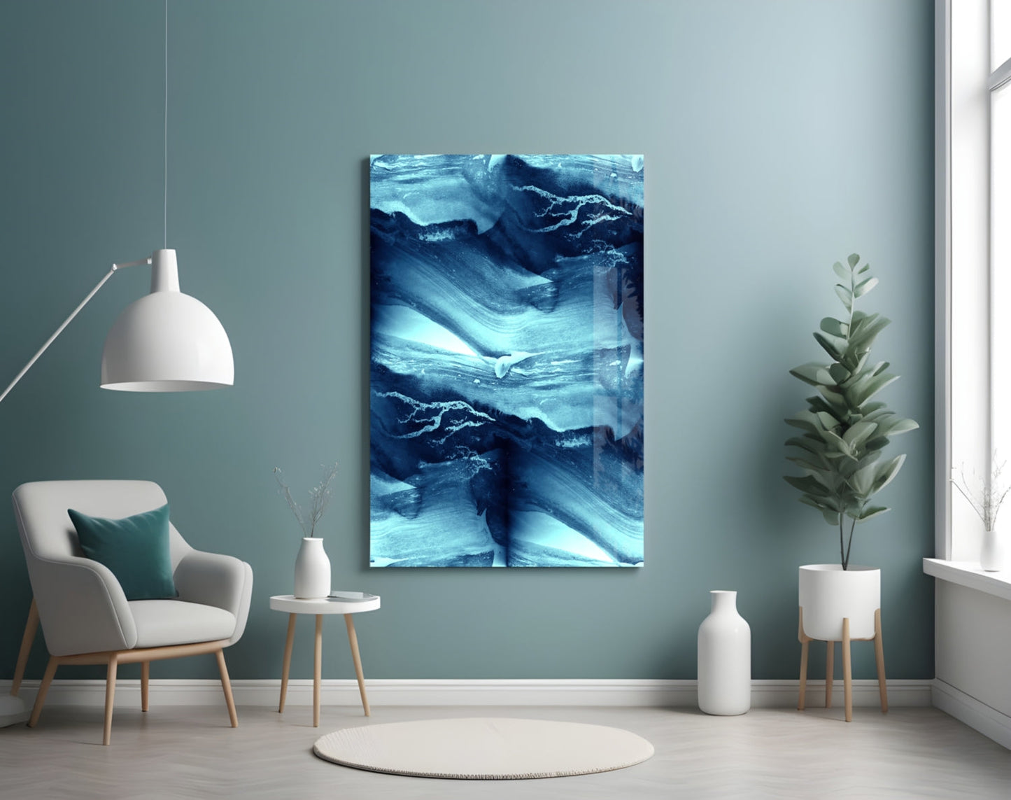 Blue Serenity Glass Wall Art displayed on teal wall above white chair in minimalist room setting with plants and pendant lamp.