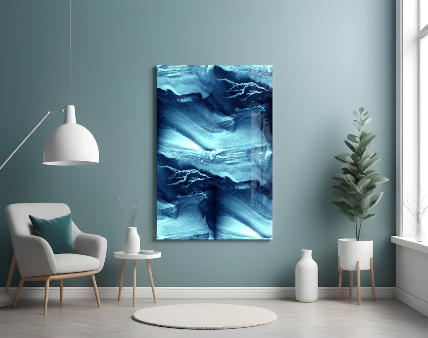Blue Serenity Glass Wall Art displayed on teal wall above white chair in minimalist room setting with plants and pendant lamp.