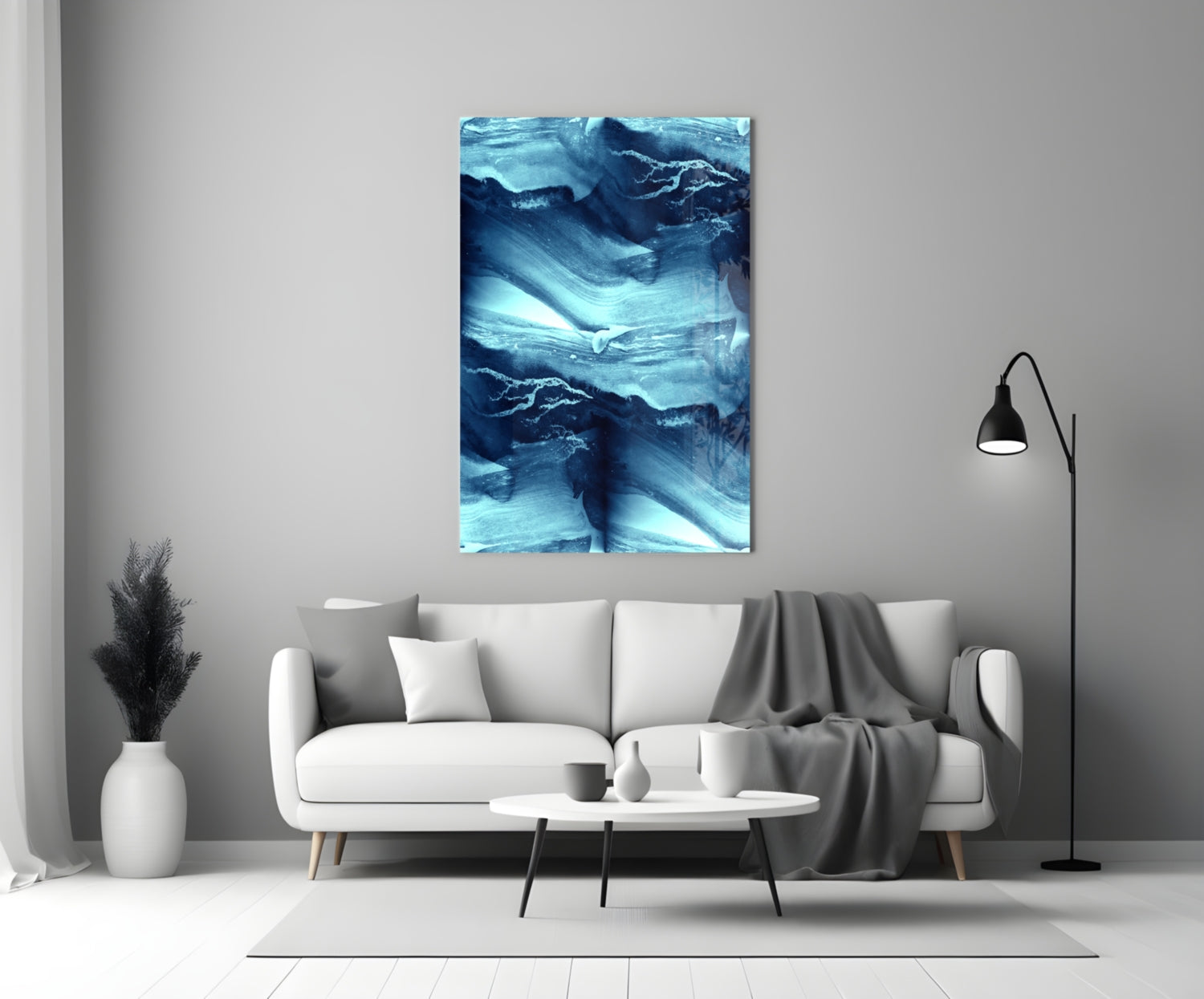 Blue Serenity Glass Wall Art displayed above a white sofa in a minimalist living room setting with neutral décor.