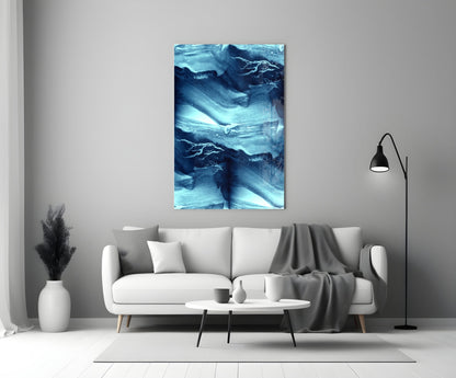 Blue Serenity Glass Wall Art displayed above a white sofa in a minimalist living room setting with neutral décor.