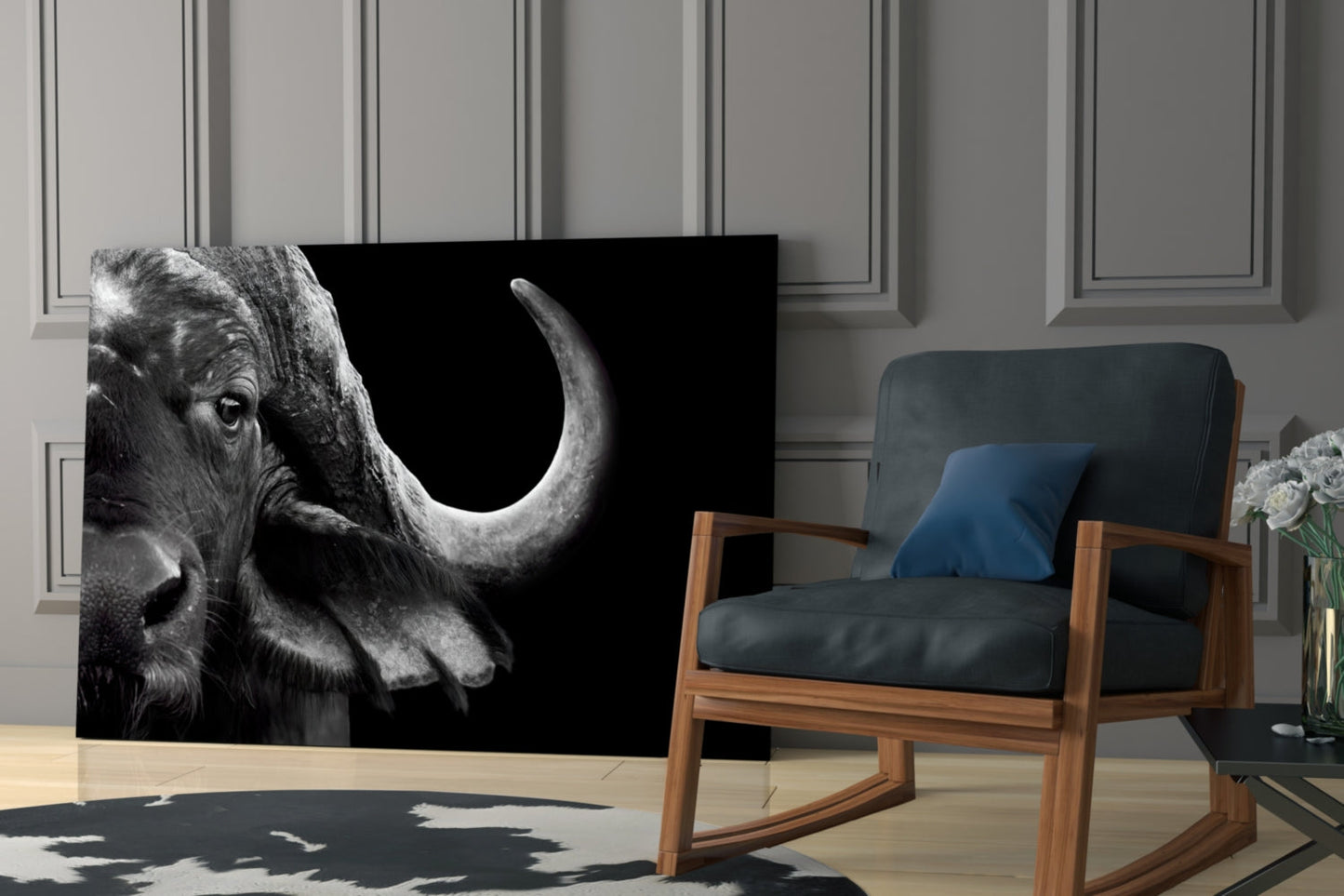 Black and white bison glass wall art displayed in a modern living room beside a wooden chair with blue cushions.