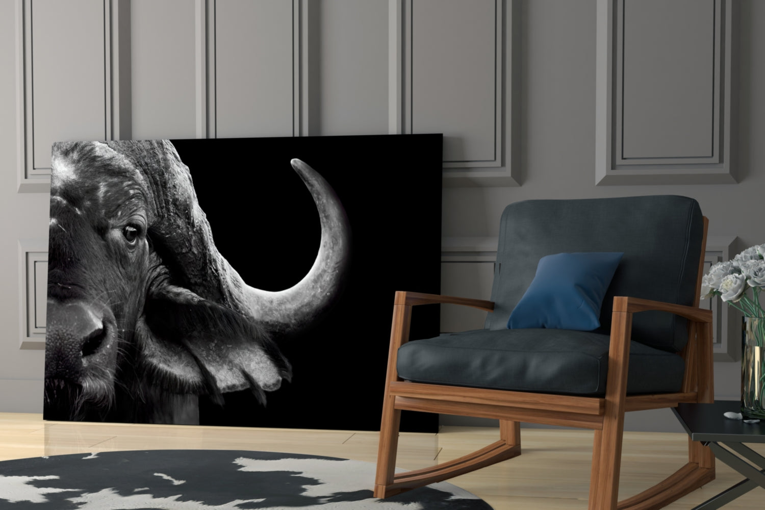 Black and white bison glass wall art displayed in a modern living room beside a wooden chair with blue cushions.