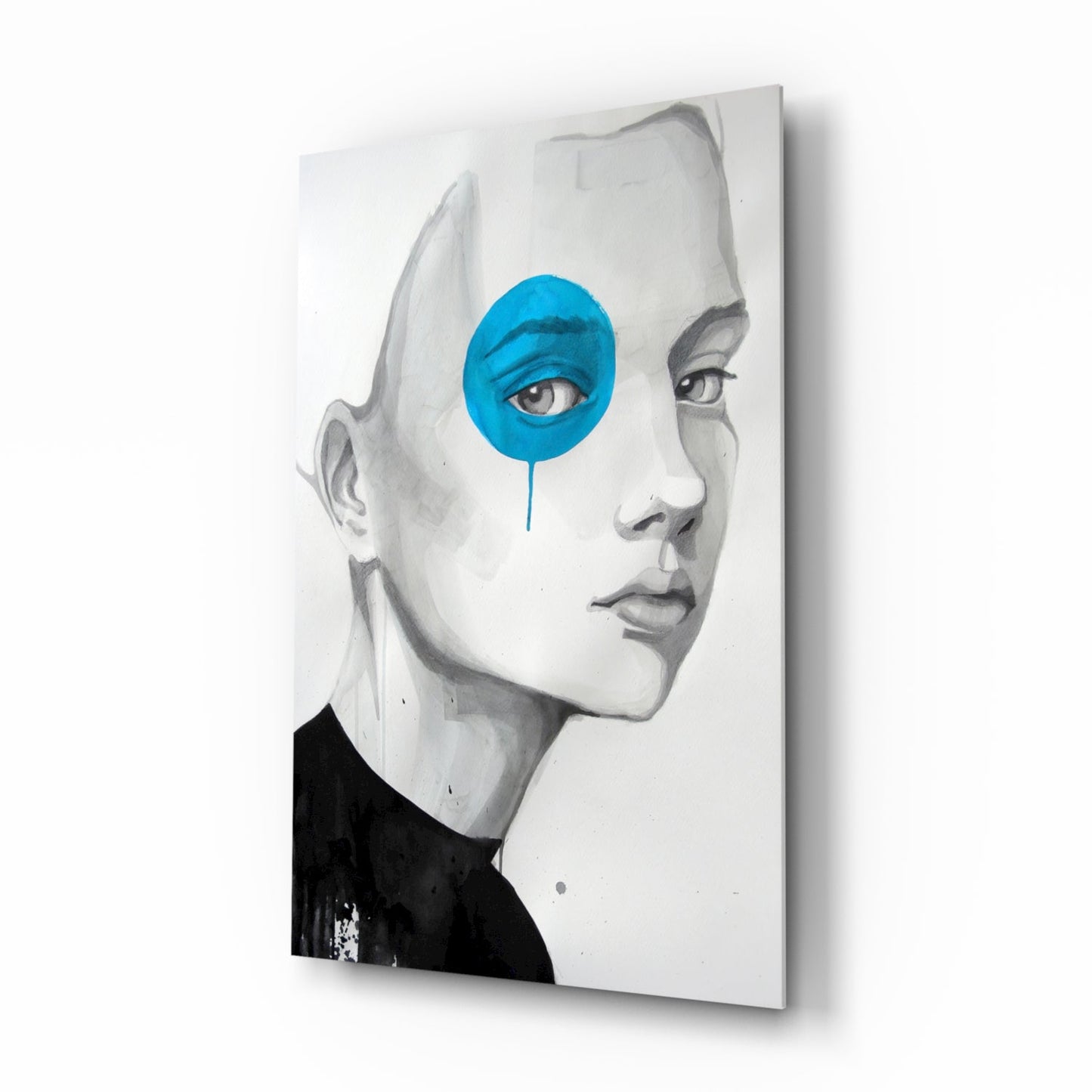 Glass wall art featuring a grayscale portrait of a child's face in profile with a bright blue circular overlay covering one eye.