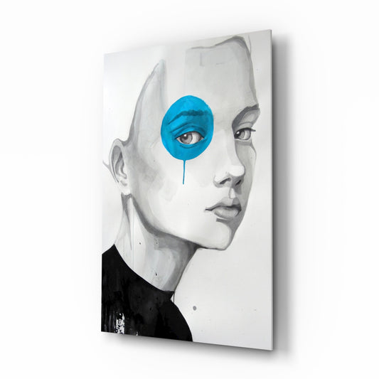 Glass wall art featuring a grayscale portrait of a child's face in profile with a bright blue circular overlay covering one eye.