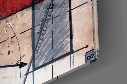 Close-up overhead view of glass wall art showing black linear marks and text on cream and tan textured surface with shadow details.