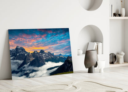 Fiery Sunset Clouds Over Rocky Peaks Glass Wall Art