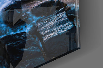 Angled view of Endless Sea Glass Wall Art displaying layered ocean rocks and blue water textures mounted on gray wall.