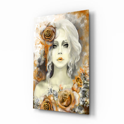 Glass wall art featuring a pale-skinned woman with white wavy hair and golden roses in warm amber and cream tones, angled perspective showing depth.