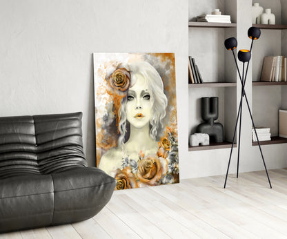 Glass wall art depicting a pale-faced woman with white wavy hair surrounded by golden roses, displayed in a modern living room setting.