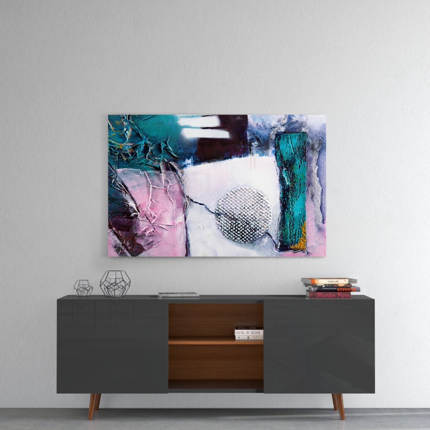 Abstract texture glass wall art in turquoise, pink, and white displayed above a mid-century modern sideboard with decorative objects.