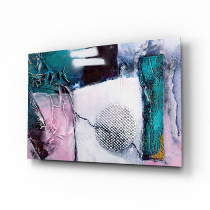 Angled view of abstract glass wall art featuring textured metallic sphere center, teal and pink paint effects, and weathered vertical elements on white background.
