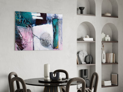 Abstract glass wall art displaying turquoise, pink, and white layered textures with geometric patterns in modern dining room setting.