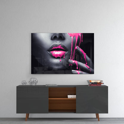 Glass wall art featuring black and white portrait with neon pink painted lips and dripping paint effect, displayed above mid-century modern sideboard.