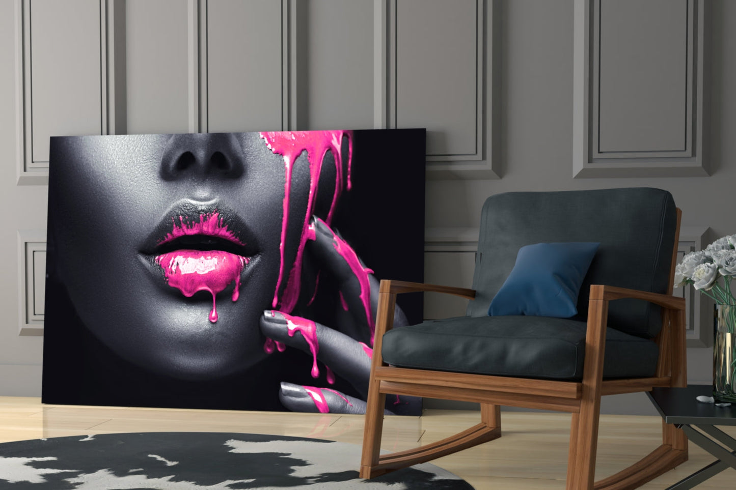 Glass wall art featuring a woman's face with bright pink dripping paint effect displayed in a modern living room setting.