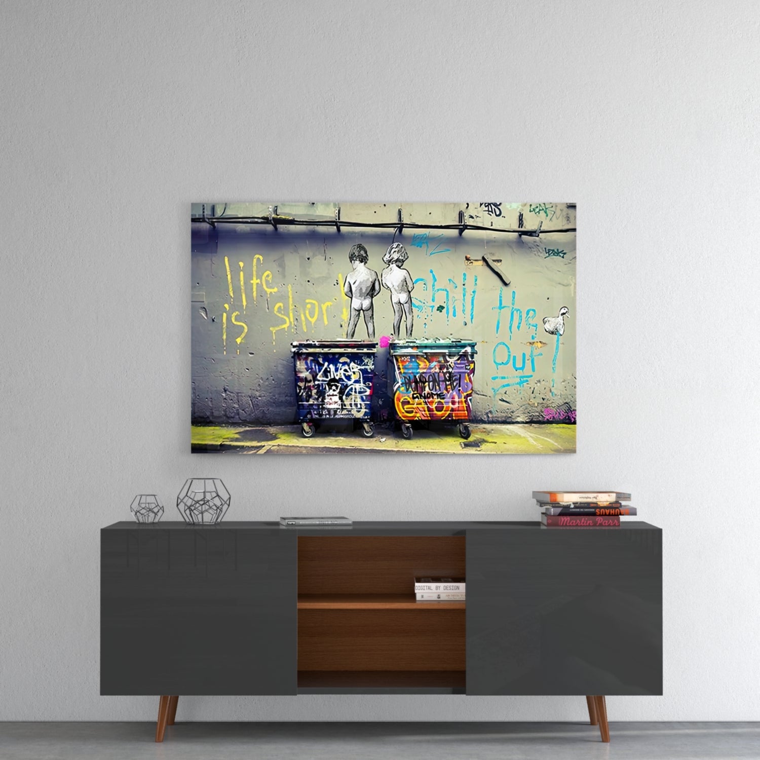Colorful street art glass wall art hanging above mid-century modern gray sideboard with wooden interior shelving.