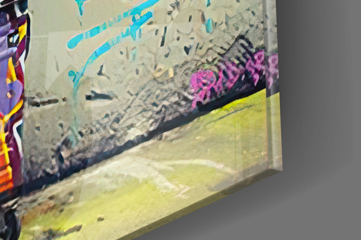 Glass wall art with colorful graffiti featuring cyan lines, pink lettering, and yellow-green sections, angled three-quarter view.