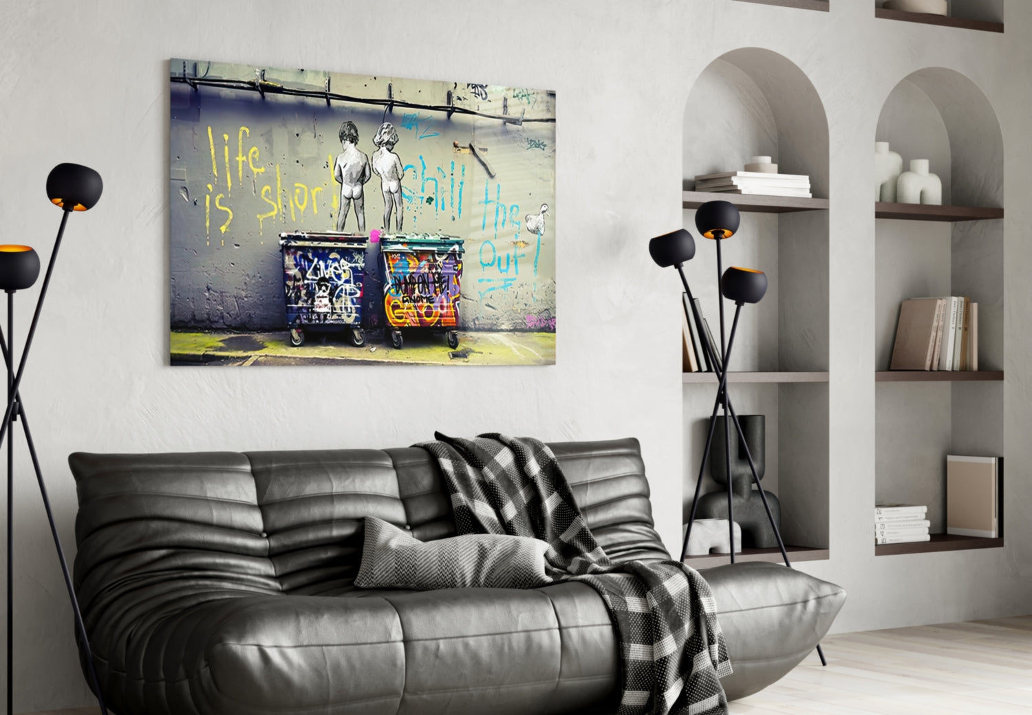 Street art glass wall panel featuring two figures and colorful graffiti with yellow "life is short" text, displayed above black leather sofa.