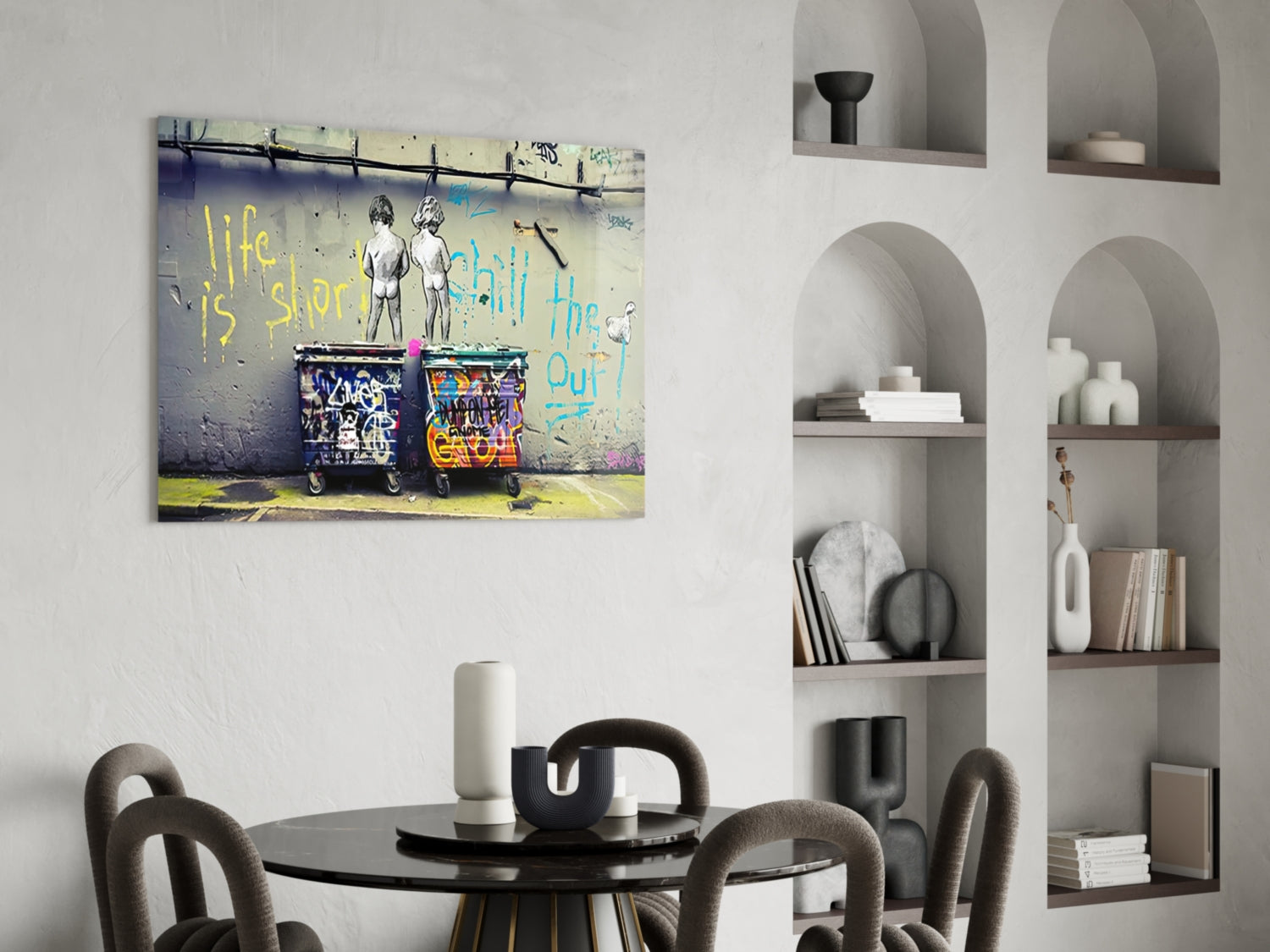 Glass wall art with street art depicting two figures and colorful text reading "life is short" displayed above a round dining table.