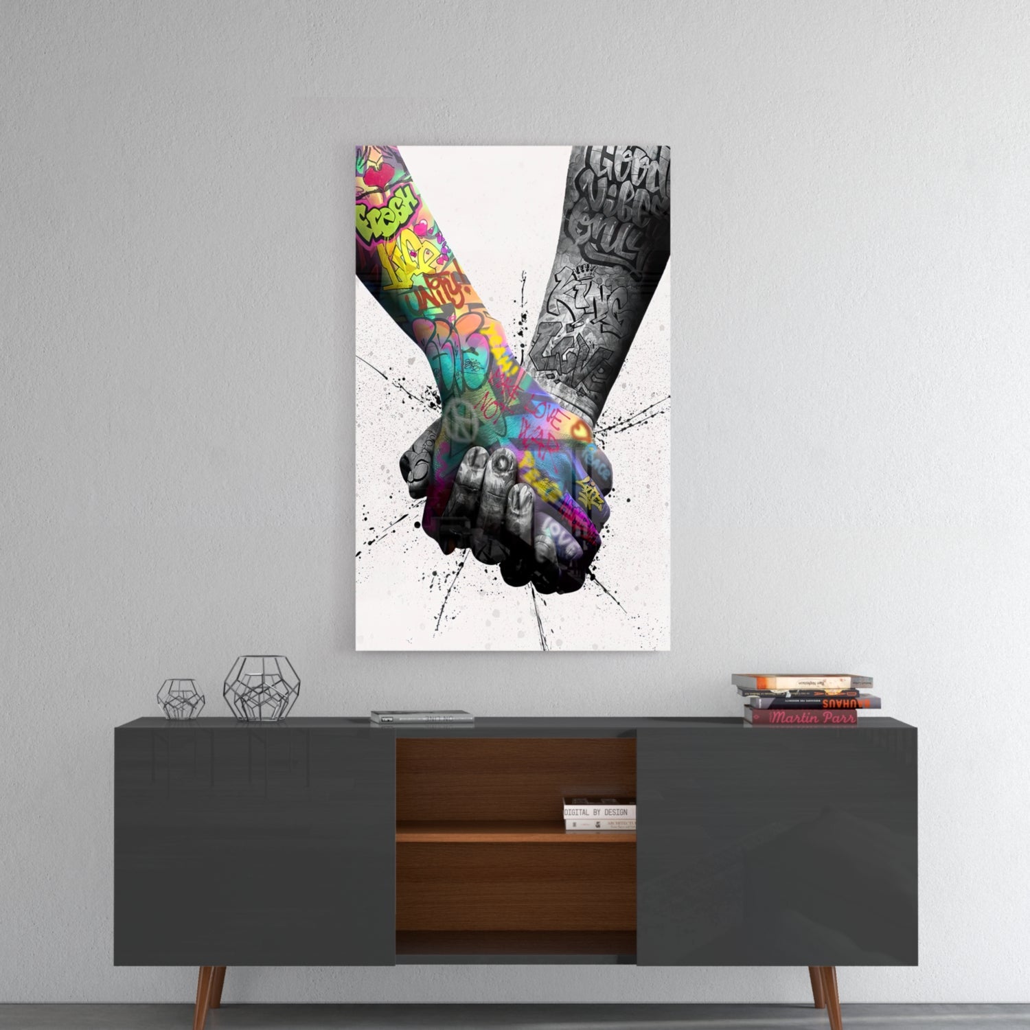 Colorful graffiti-style glass wall art depicting two tattooed hands holding, displayed above a mid-century modern credenza.
