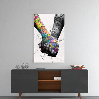 Colorful graffiti-style glass wall art depicting two tattooed hands holding, displayed above a mid-century modern credenza.