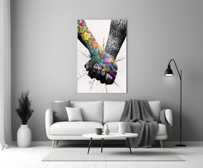 Colorful glass wall art depicting two tattooed hands holding together displayed above a white sofa in a minimalist living room.