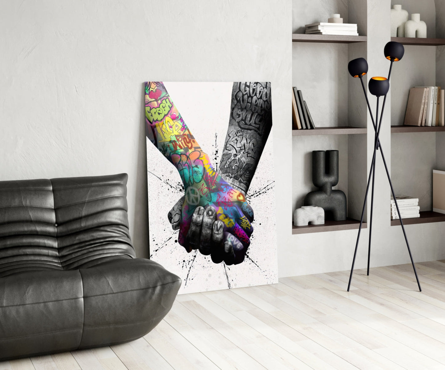 Modern living room interior with colorful graffiti hand peace sign glass wall art displayed next to black leather chair and floor lamp.
