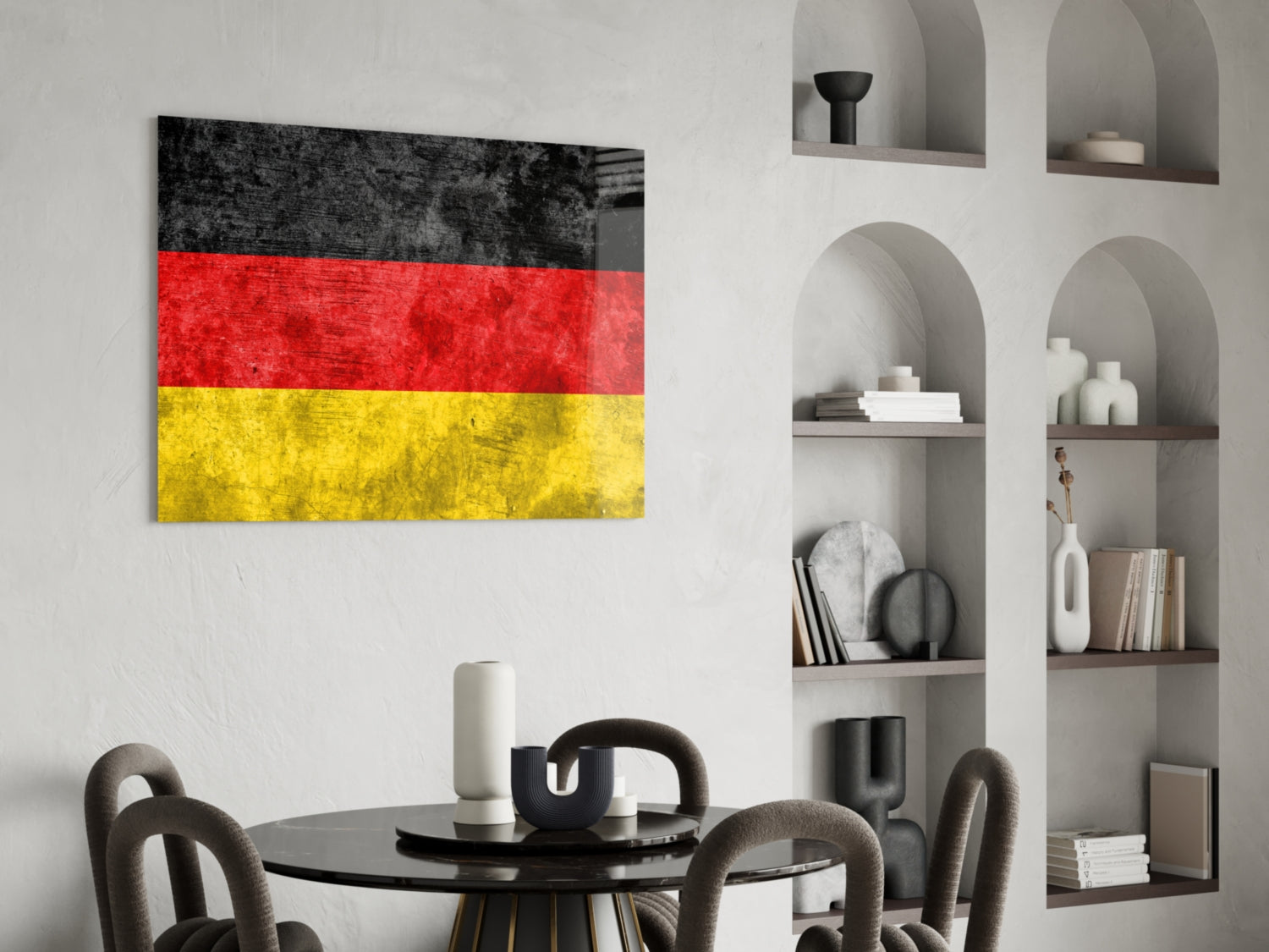 German flag glass wall art with black, red, and yellow horizontal stripes displayed above dining table in modern interior.