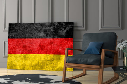 German flag glass wall art with black, red, and yellow horizontal stripes displayed in modern living room interior.