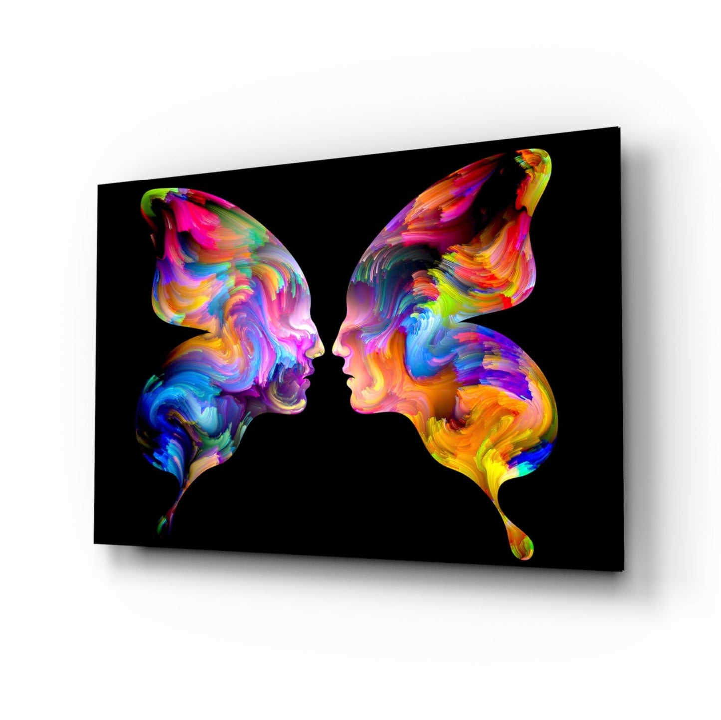 Two colorful silhouetted profiles facing each other on black glass with vibrant rainbow paint swirl patterns.
