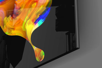 Colorful glass butterfly wall art with vibrant yellow, orange, red, and blue gradient brushstroke design displayed on gray wall.