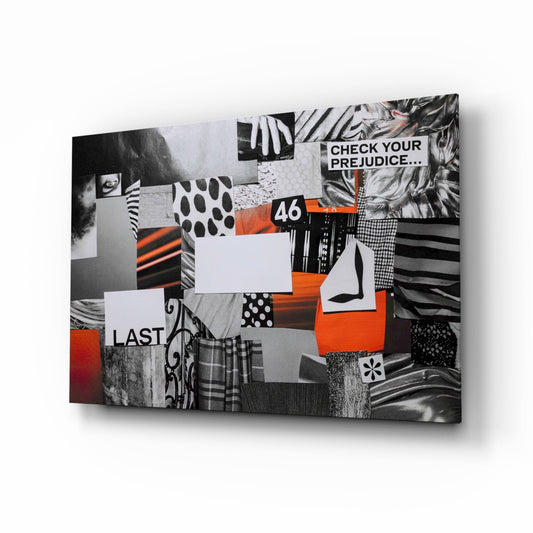 Angled three-quarter view of glass wall art featuring black and white patterned collage with orange accents, displaying text "CHECK YOUR PREJUDICE," "A6," and "LAST.