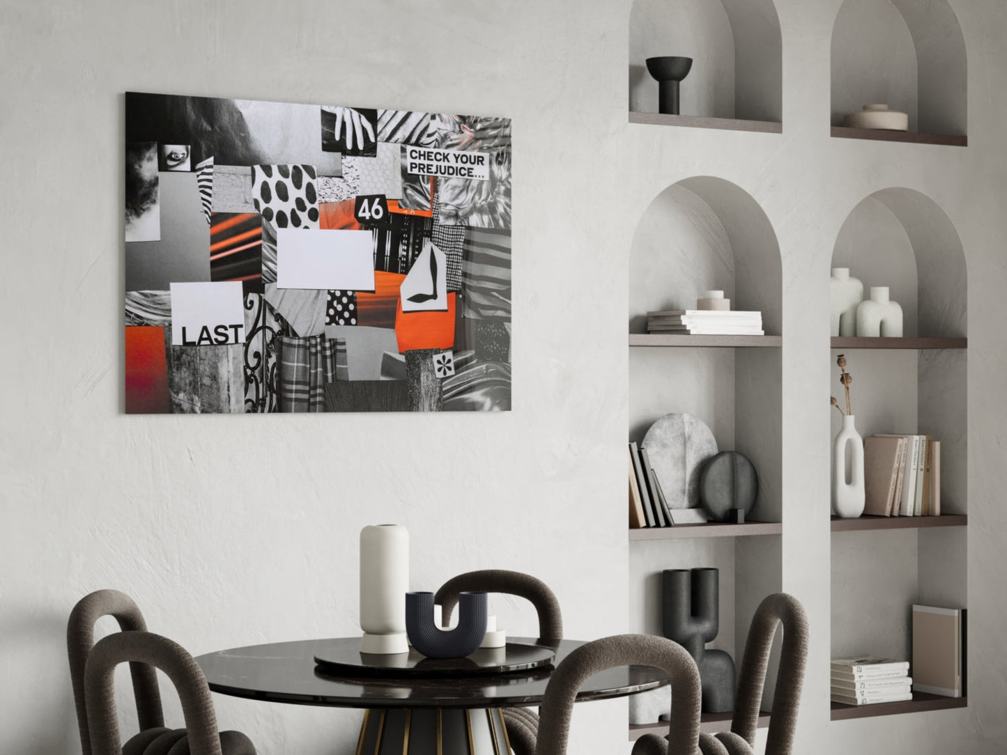 Collage-style glass wall art featuring black, white, and orange geometric patterns with text including "CHECK YOUR PREJUDICE" and "LAST" displayed above a round dining table.