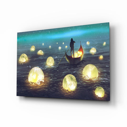 Glass wall art displayed at an angle showing a figure in a boat surrounded by glowing yellow egg-shaped objects on dark water under a turquoise aurora sky.
