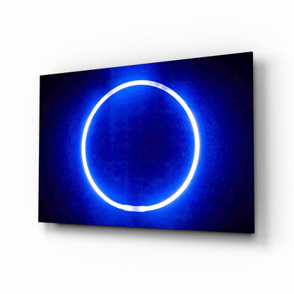 Blue neon ring glowing on dark background, displayed at an angle on a white wall.