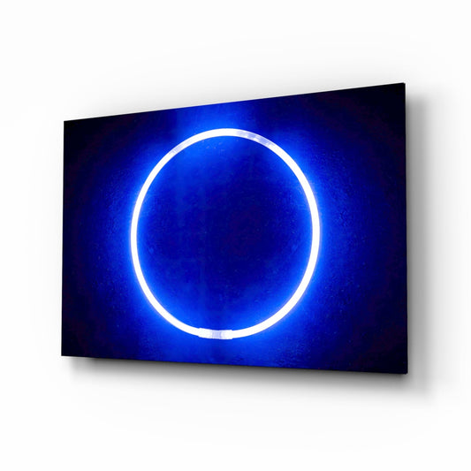 Blue neon ring glowing on dark background, displayed at an angle on a white wall.
