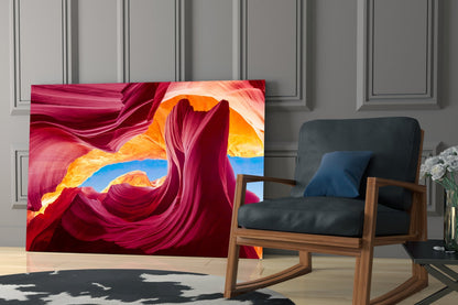 Red Valley glass wall art displaying vibrant magenta, orange, and blue flowing patterns installed in modern living room setting.