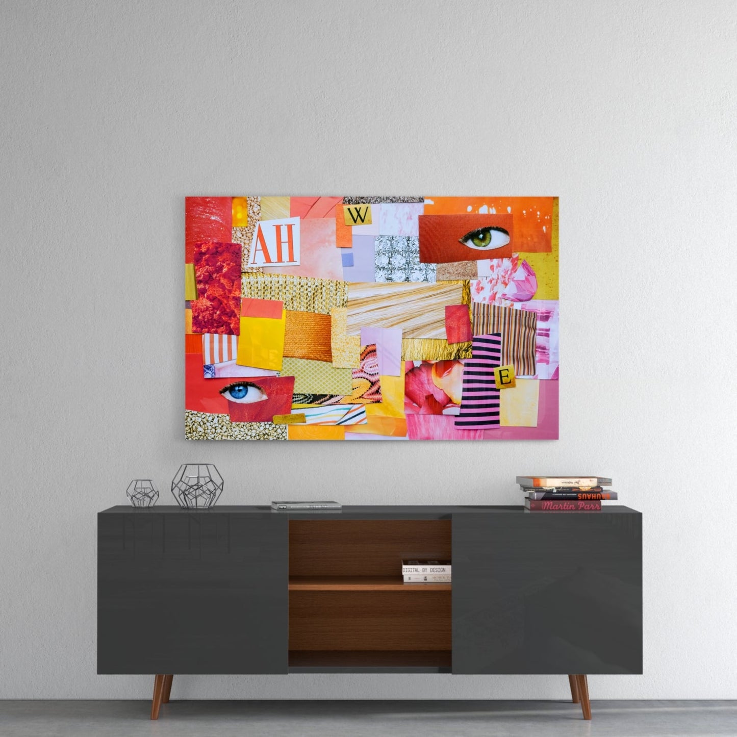 Colorful patchwork glass wall art featuring geometric shapes, eyes, and text mounted above a dark mid-century modern sideboard.
