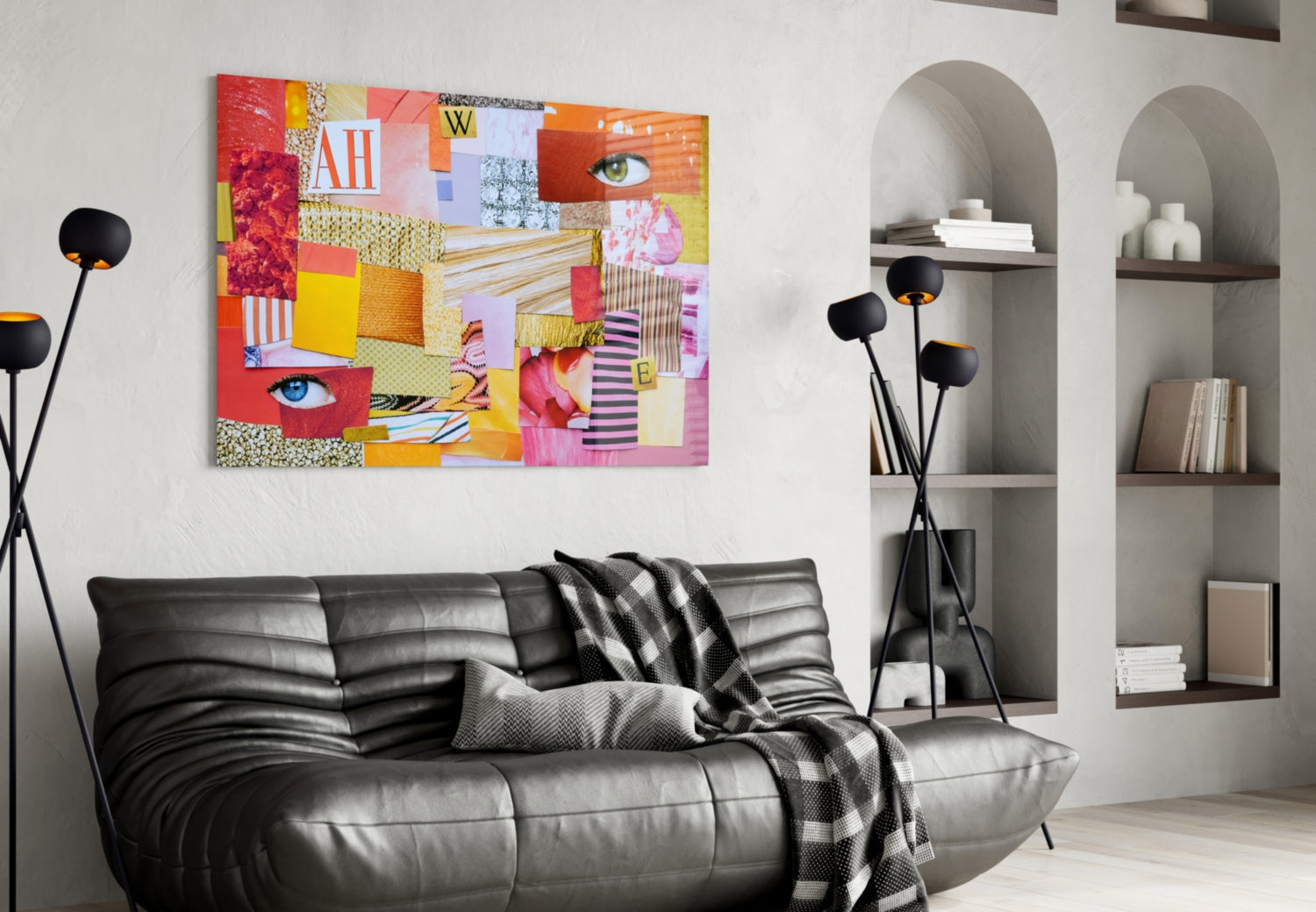 Colorful patchwork glass wall art with red, yellow, pink, and orange sections featuring eyes and text, displayed above a black leather sofa in a modern living room.