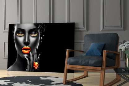 Modern living room displaying black and gold portrait glass art on wall beside wooden chair with blue cushions.