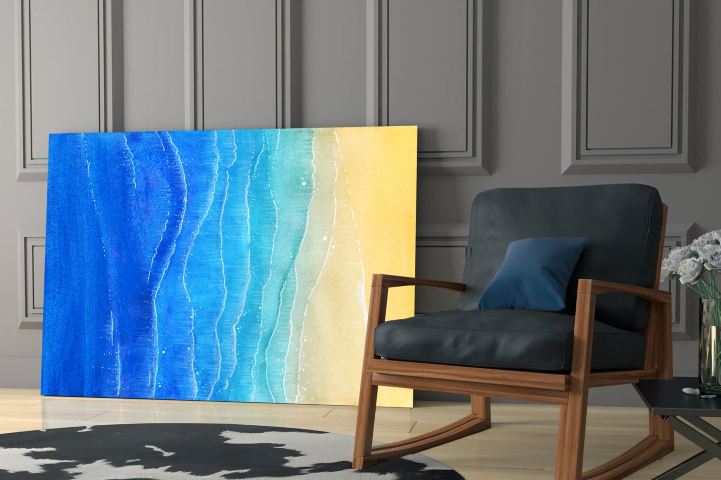 Sea Sand Glass Wall Art displaying gradient blue to yellow ocean waves texture, displayed in modern interior with wooden chair and gray paneled wall.