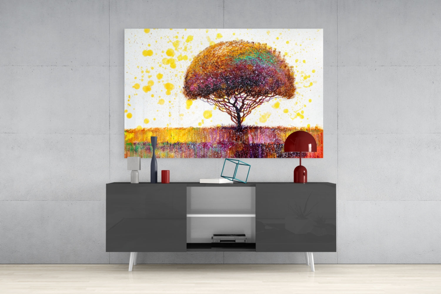 Colorful tree glass wall art displayed above a dark gray media console, showing a vibrant umbrella-shaped tree with multicolored foliage and yellow splatter effects.