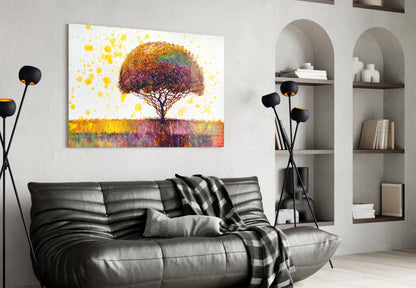 Colorful tree glass wall art displayed above black leather sofa in modern living room with white shelving and black floor lamp.