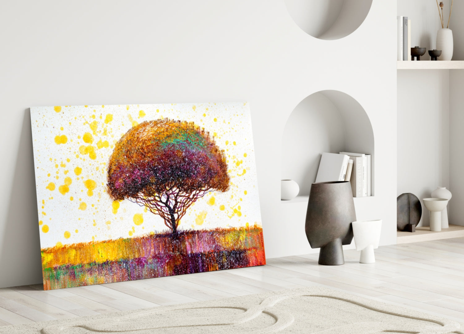 Colorful tree glass wall art leaning against white wall in minimalist room with sand patterns and decorative objects.