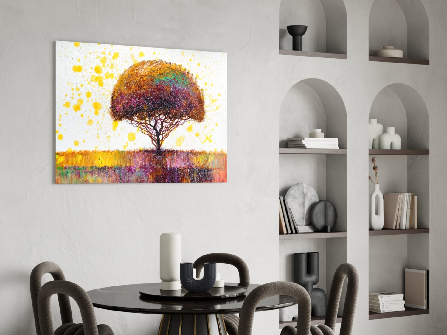Colorful tree glass wall art with multicolored canopy displayed above black dining table in modern interior setting.