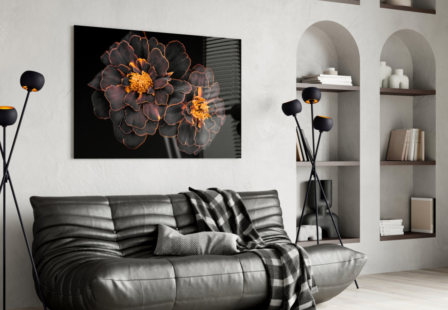 Brown flower glass wall art with orange center displayed above a gray leather sofa in modern living room setting.