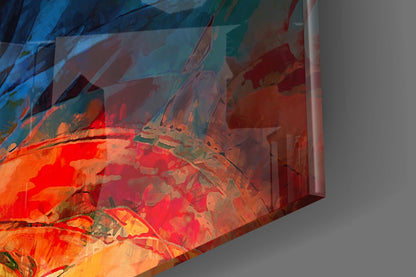 Close-up angled view of translucent glass wall art displaying layered red, orange, and blue fractal flower patterns against neutral background.