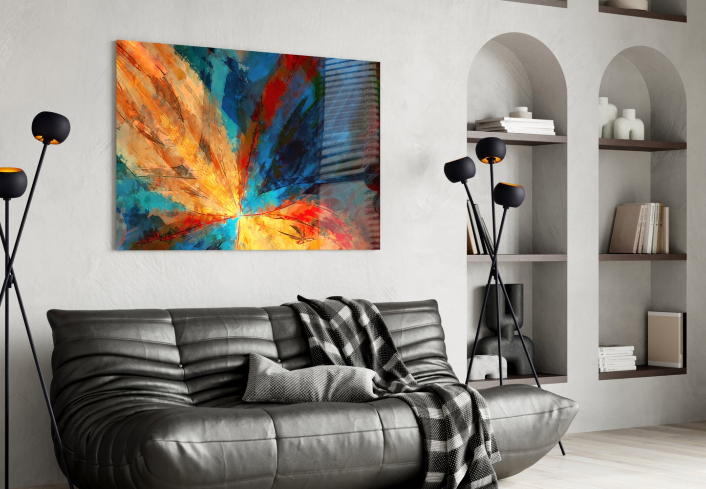Colorful abstract fractal flower glass art hanging above a black leather sofa in a modern living room interior.