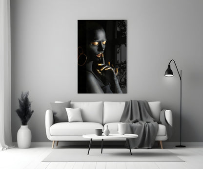 Silent Woman Glass Wall Art displayed above a white sofa in a minimalist living room, featuring a portrait with gold accents on black background.