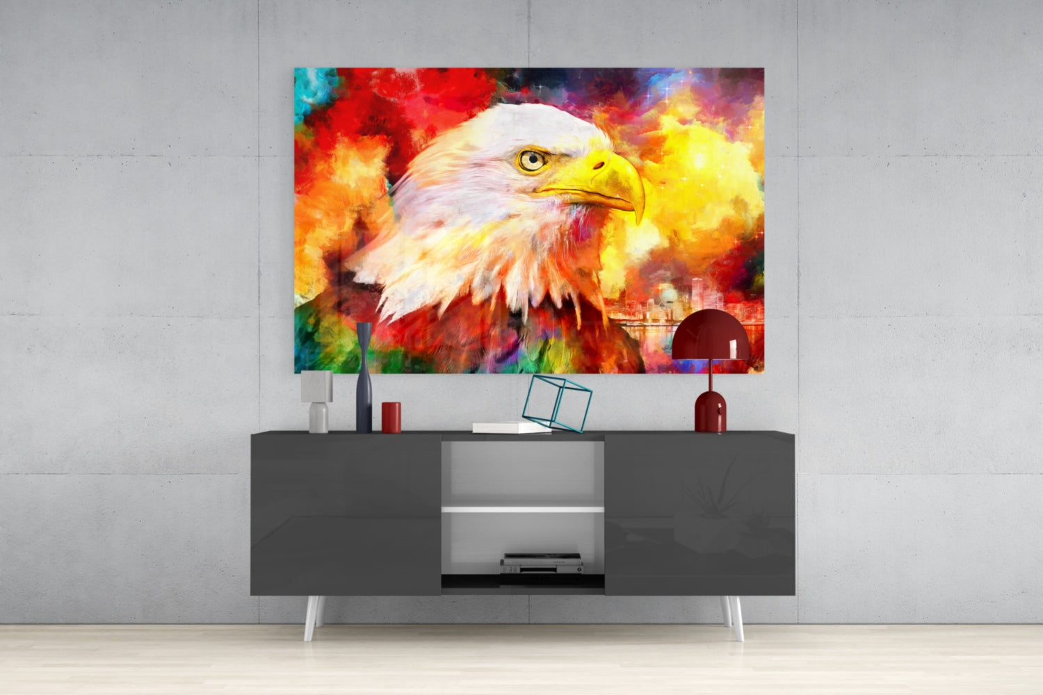 Vibrant glass wall art depicting an eagle with white head and colorful fire background, displayed above a dark media console in a modern interior setting.