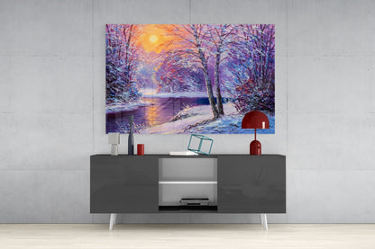 Colorful winter landscape glass wall art depicting a snowy forest scene with purple trees and golden sunset displayed above a modern gray media console.